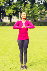 Image showing smiling woman exercising outdoors