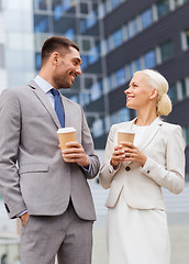 Image showing smiling businessmen with paper cups outdoors