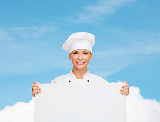 Image showing smiling female chef with white blank board