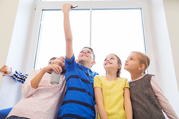 Image showing group of school kids with smartphone and soda can