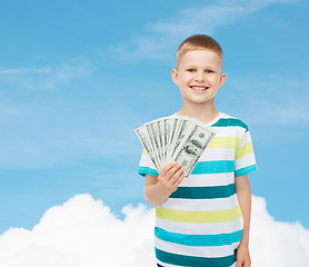 Image showing smiling boy holding dollar cash money in his hand