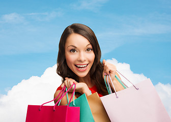 Image showing smiling woman with colorful shopping bags