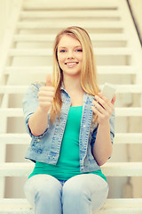 Image showing smiling female student with smartphone