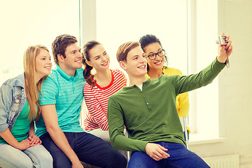 Image showing five smiling students taking picture with camera