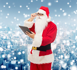 Image showing man in costume of santa claus with tablet pc