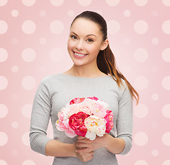 Image showing smiling young woman with flower