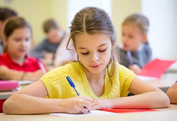 Image showing group of school kids writing test in classroom