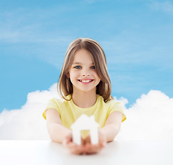 Image showing beautiful little girl holding paper house cutout