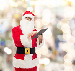 Image showing man in costume of santa claus with tablet pc