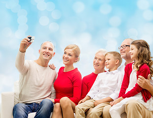 Image showing smiling family with camera