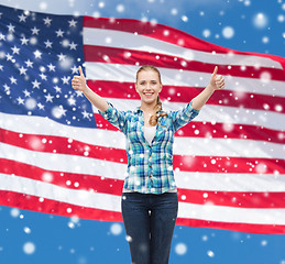 Image showing smiling girl in casual clothes showing thumbs up