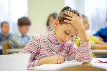 Image showing group of school kids writing test in classroom