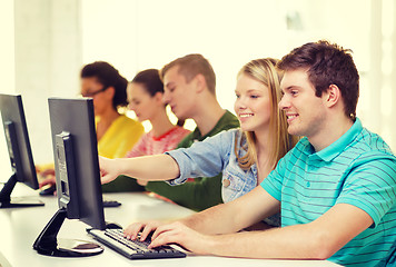 Image showing smiling students in computer class at school