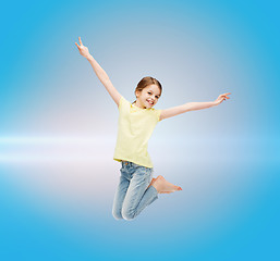 Image showing smiling little girl jumping