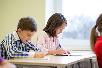 Image showing group of school kids writing test in classroom