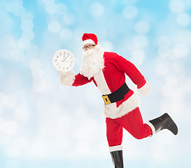 Image showing man in costume of santa claus with clock