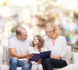 Image showing happy family with book at home