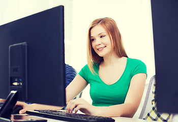 Image showing smiling female student in computer class