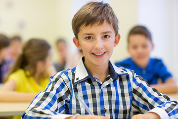 Image showing group of school kids writing test in classroom