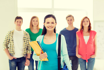 Image showing smiling students with teenage girl in front