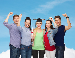 Image showing group of standing smiling students with diploma