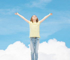 Image showing smiling teenage girl with raised hands