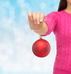 Image showing close up of woman in sweater with christmas ball