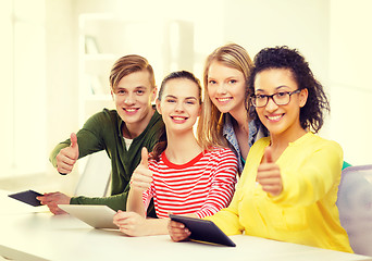 Image showing smiling students with tablet pc at school