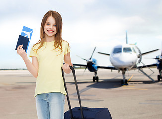 Image showing smiling girl with travel bag ticket and passport