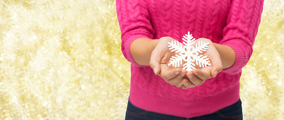 Image showing close up of woman holding snowflake decoration