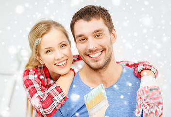 Image showing smiling couple with paintbrush at home