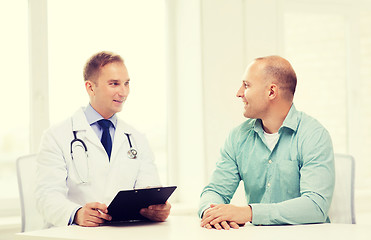 Image showing doctor with clipboard and patient in hospital