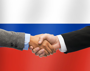 Image showing close up of handshake over russian flag