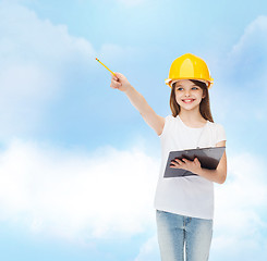 Image showing smiling little girl in hardhat with clipboard