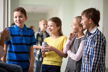 Image showing group of school kids with soda cans in corridor