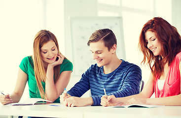 Image showing smiling students with textbooks at school