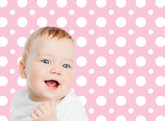 Image showing smiling baby girl face over pink polka dots