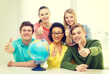 Image showing five smiling student with earth globe at school