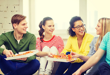 Image showing five smiling teenagers eating pizza at home