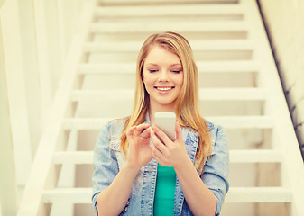 Image showing smiling female student with smartphone