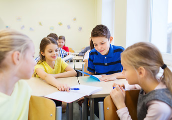 Image showing group of school kids writing test in classroom