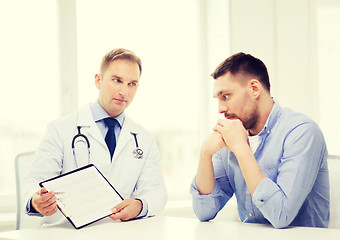 Image showing doctor with clipboard and patient in hospital