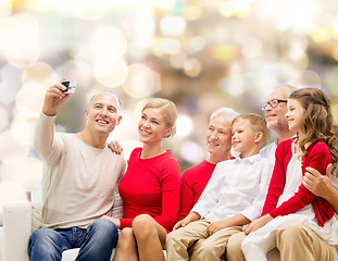 Image showing smiling family with camera