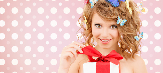 Image showing smiling young woman with gift box