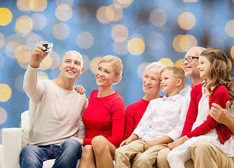 Image showing smiling family with camera