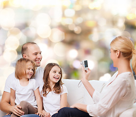 Image showing happy family with camera at home