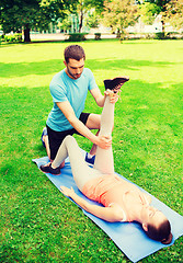 Image showing serious couple stretching outdoors