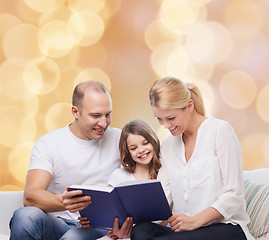 Image showing happy family with book at home