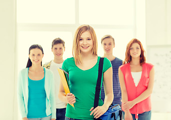 Image showing smiling students with teenage girl in front