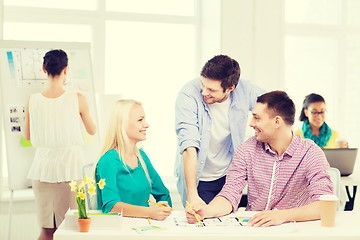 Image showing smiling interior designers working in office